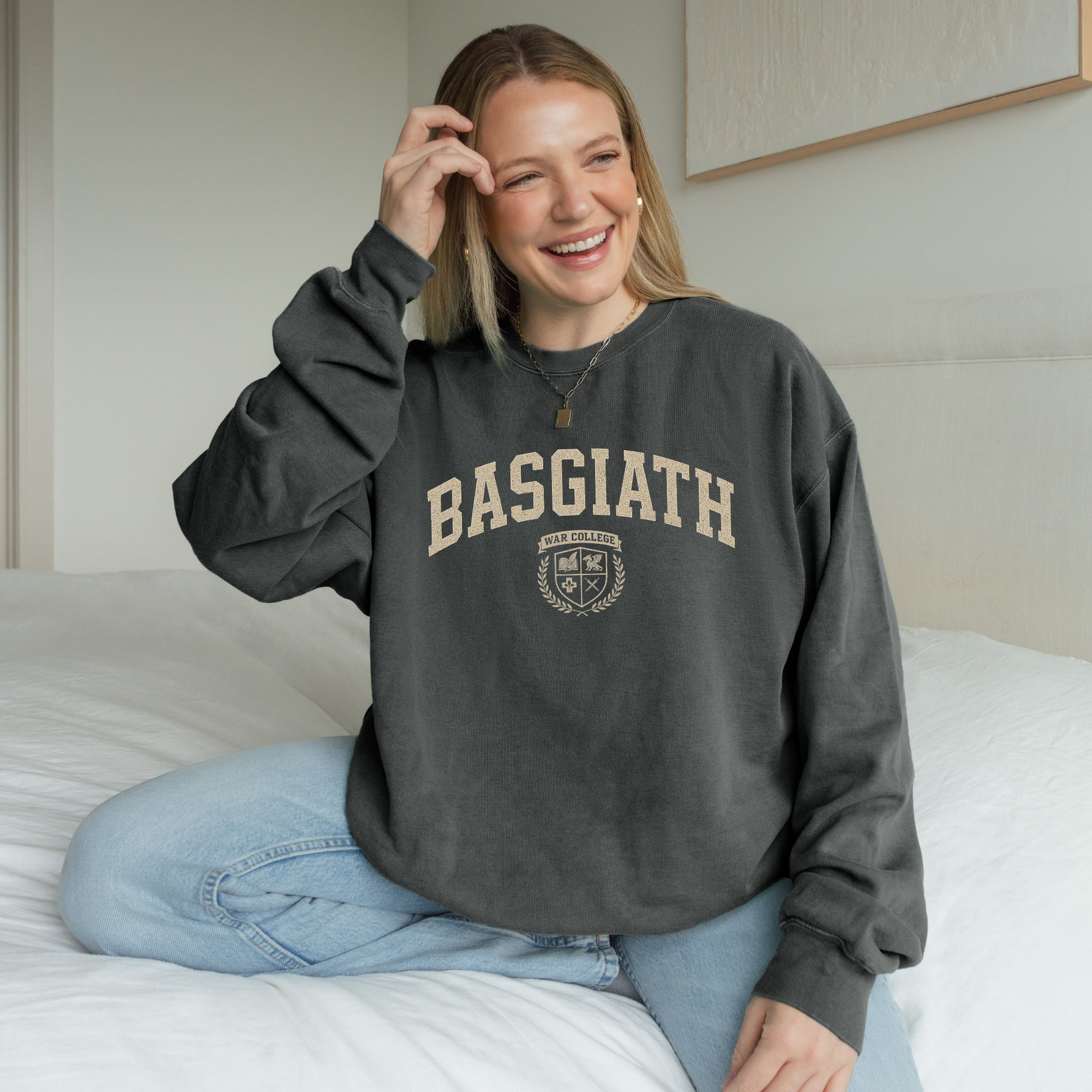 Woman wearing Basgiath War College sweatshirt inspired by Fourth Wing – subtle fantasy book merch for Violet Sorrengail fans